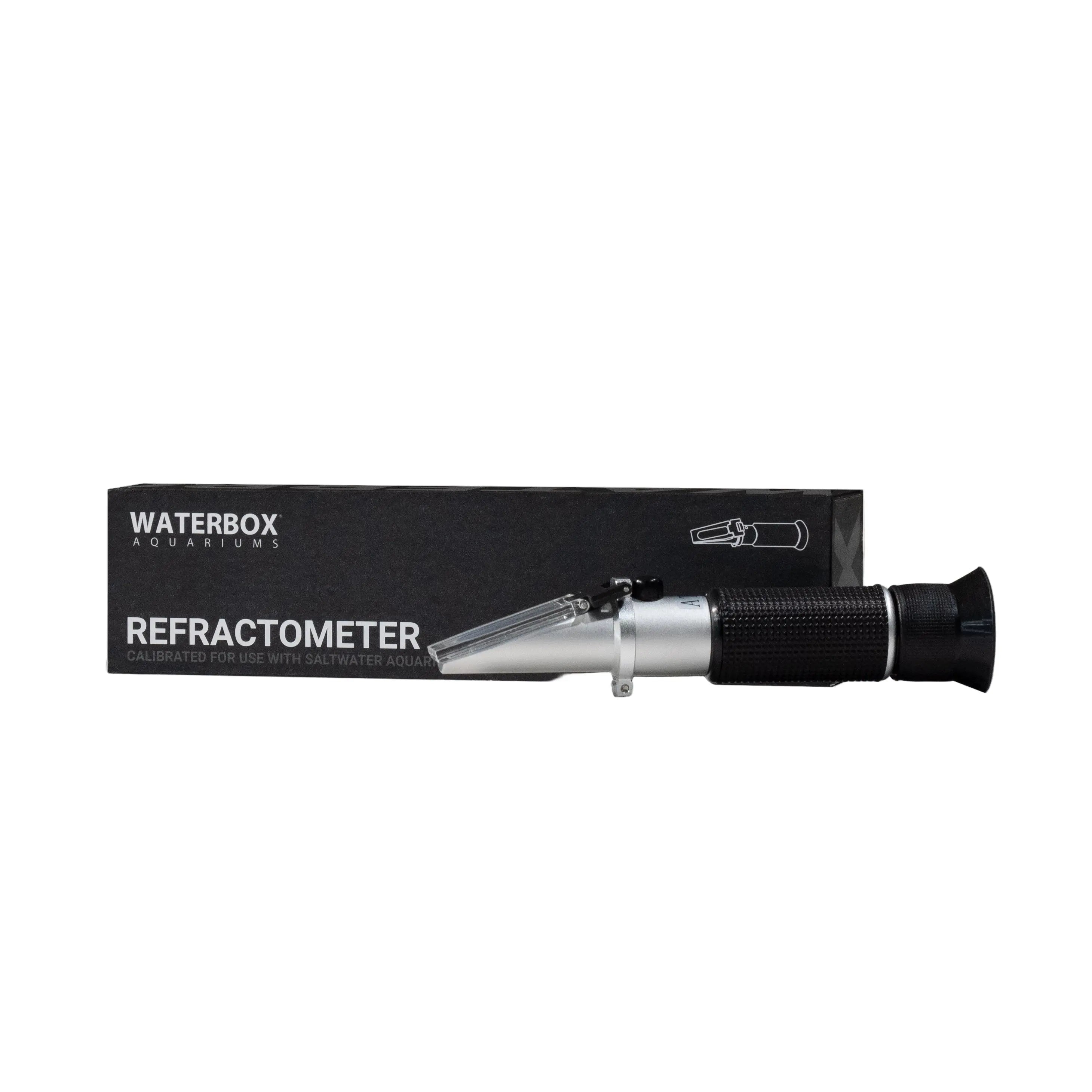 A Waterbox Aquariums Refractometer designed for measuring seawater, with a black body and silver accents, displayed alongside its packaging box.