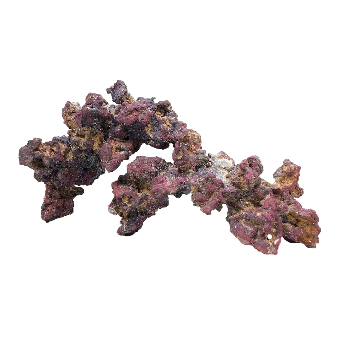 An irregularly shaped, multicolored aquarium rock on a white background.