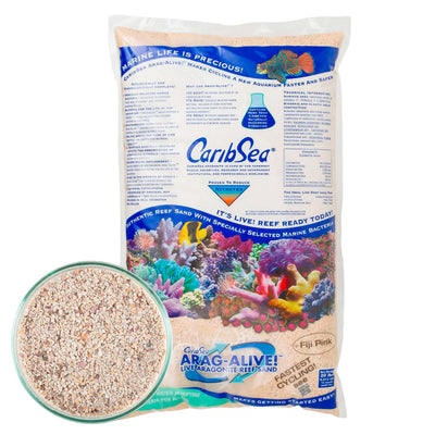 A package of CaribSea Arag-Alive Fiji Pink live sand for aquariums, showing the bag with a picture of the sand and an aquarium scene, along with a close-up view of the sand texture.