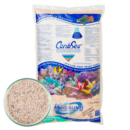 A package of CaribSea Arag-Alive Fiji Pink live sand for aquariums, showing the bag with a picture of the sand and an aquarium scene, along with a close-up view of the sand texture.